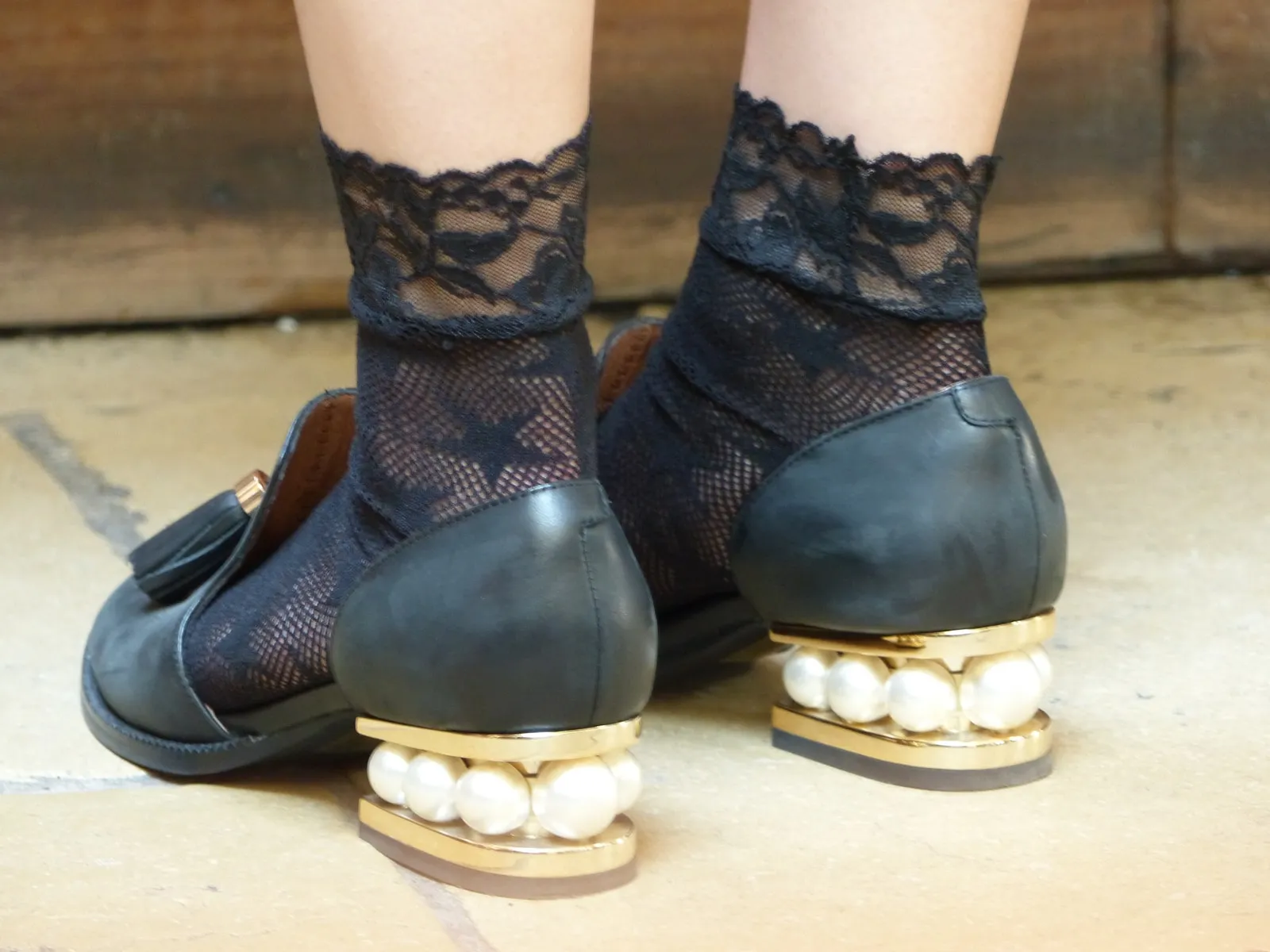 Black lace socks with black shoes on pearl heels