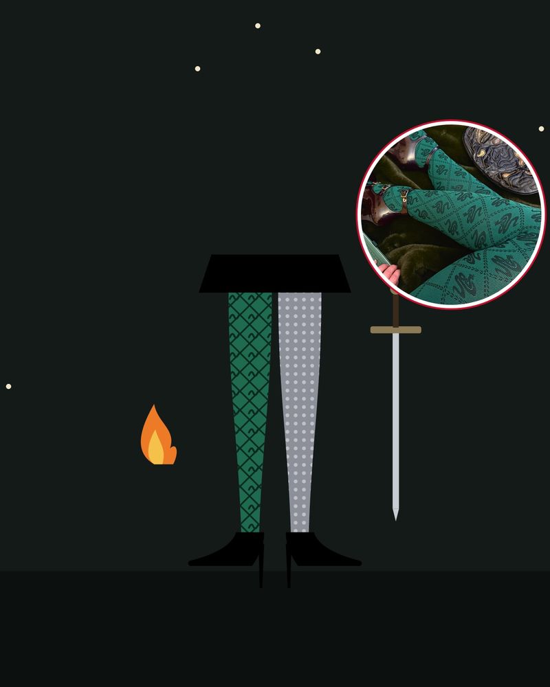 Illustration: at night, one leg in dark green tights with a diamond pattern of small snakes and one in silver grey tights, with black pumps, next to a sword and a small orange flame, with a photo of Snag's green snake tights in the circle
