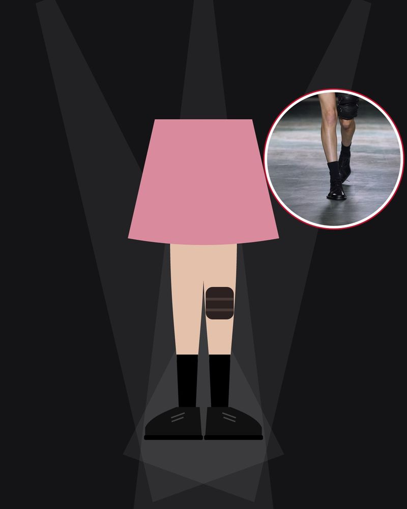 Illustration: legs in black socks, black derbies and a leather knee pad under a pink mini dress, between beams of light in a dark room, with a photo of the runway look