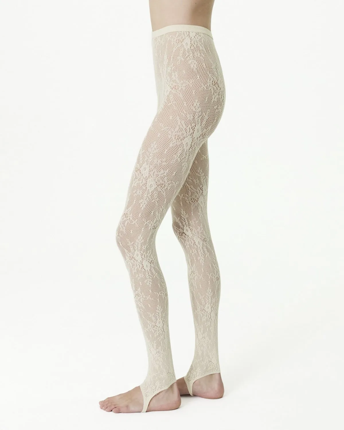 Ivory floral lace stirrup tights on bare feet, the stirrup under the arch